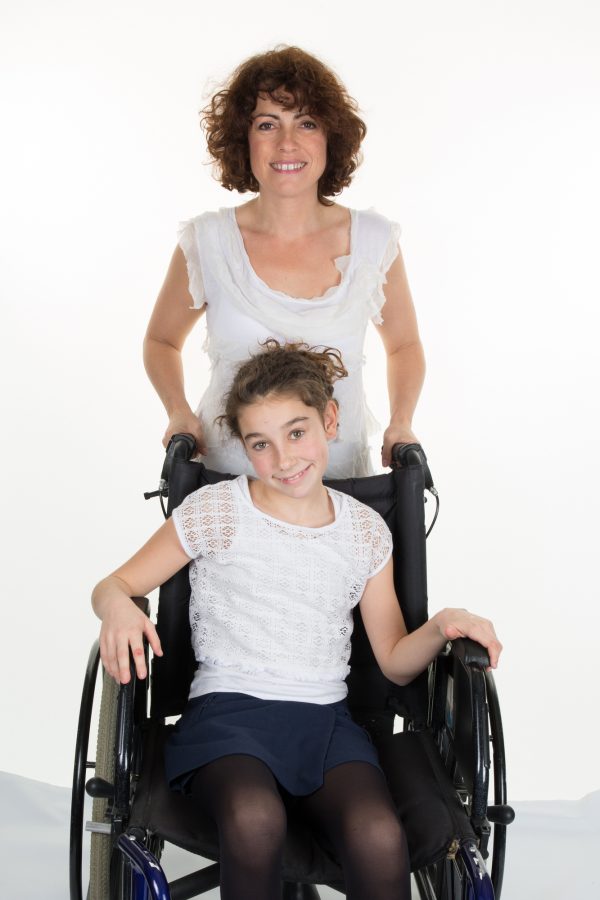 online certificate in disability: girl is on a wheel chair with an adult behind her