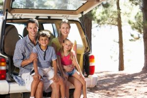 self-care: family of four sitting in the back of their car