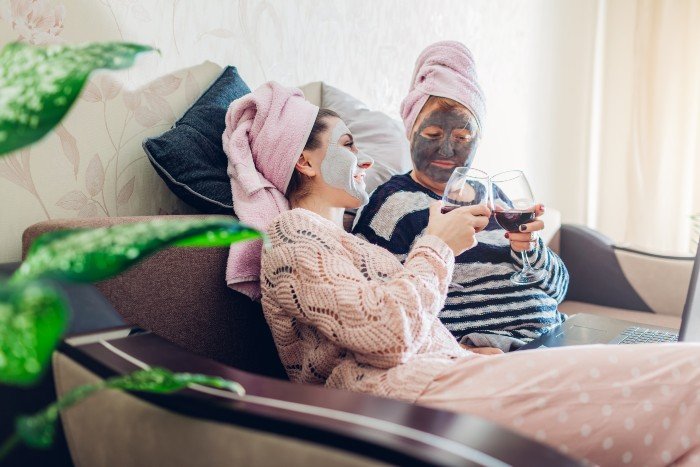 work from home: two mums pampering themselves with a facial mask