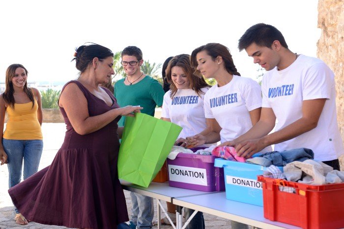 a group of volunteers receiving donations