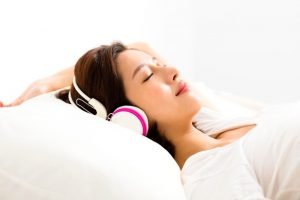 girl sleeping soundly with a headset on