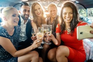 event management: group of party goers toasting and drinking