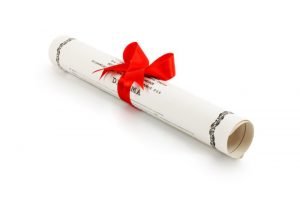 a rolled diploma with a red ribbon