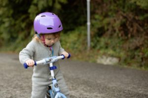 outings for less: child is riding on a bike in the outdoors